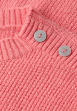 Trui met knoopdetail